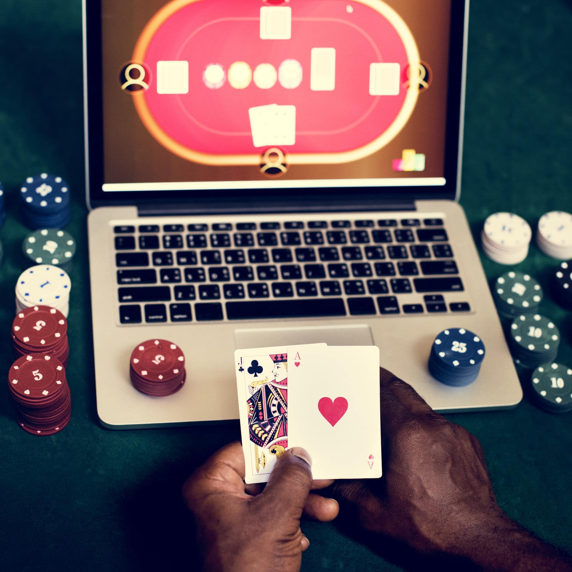 Hand holding card playing online gambling