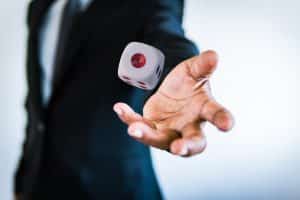 Business man throwing the dice gambling game in hand concept