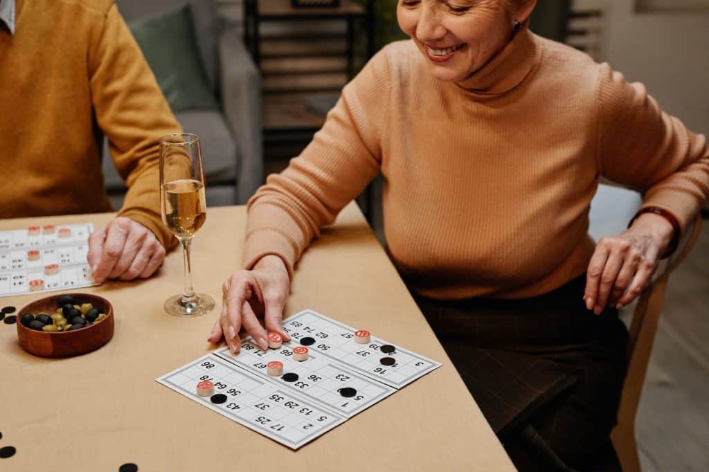 Woman playing board game with friends
