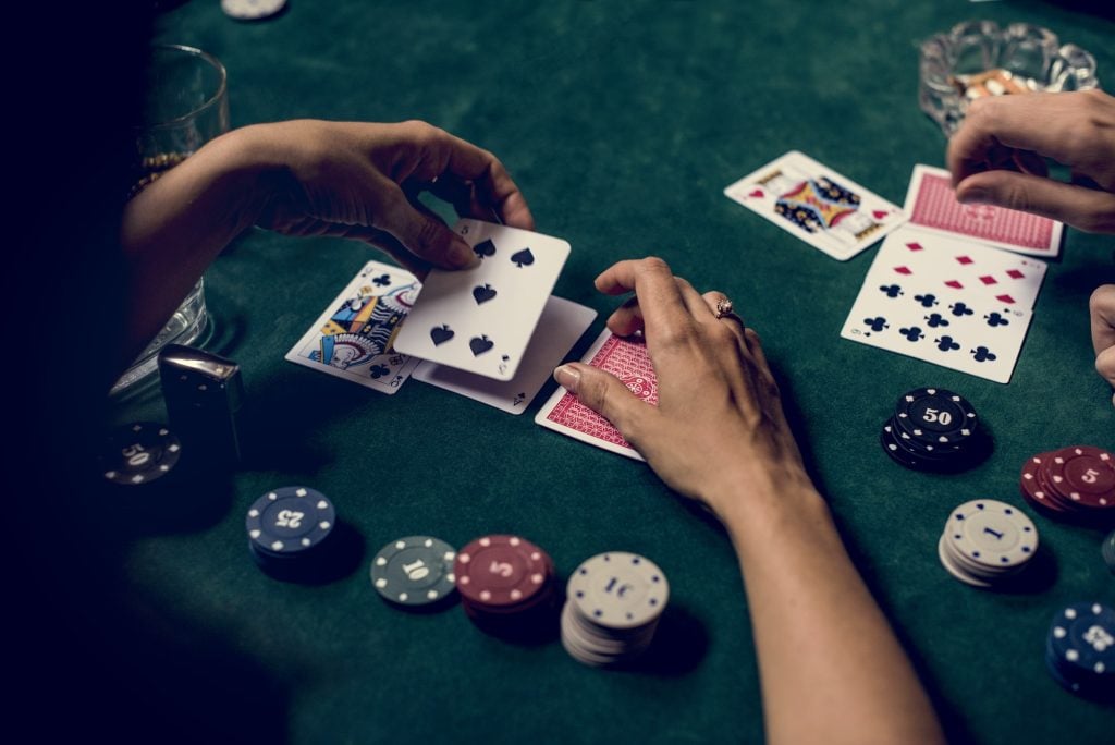 Hands holding card on gambling game