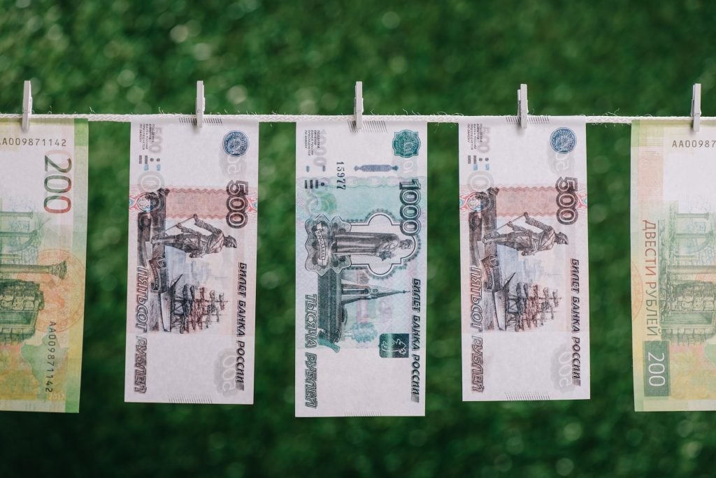 rubles banknotes hanging with clothespins on clothesline, money laundering concept