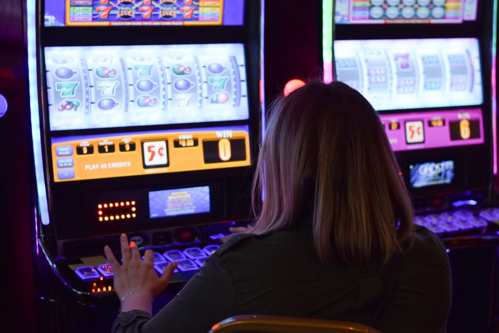 Woman from behind playing slot machines at Fallsview Casino Niagara Falls