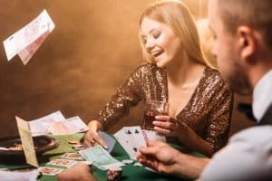 happy-attractive-girl-playing-poker-with-croupier-2023-11-27-05-17-35-utc