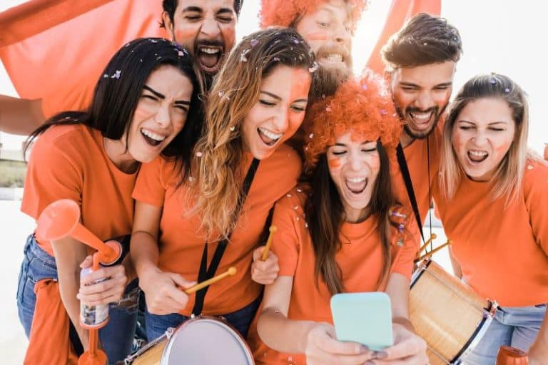Orange-sport-supporters-watching-football-game-on-2023-11-27-05-36-25-utc